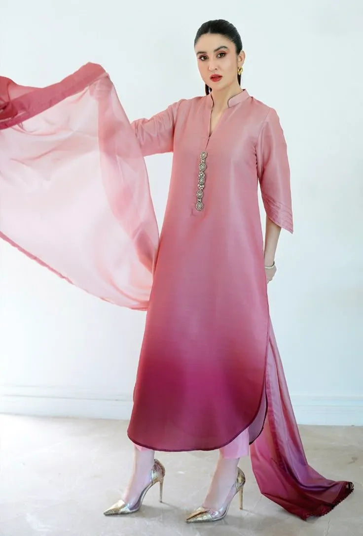 Woman wearing a pink and red traditional outfit with a white background