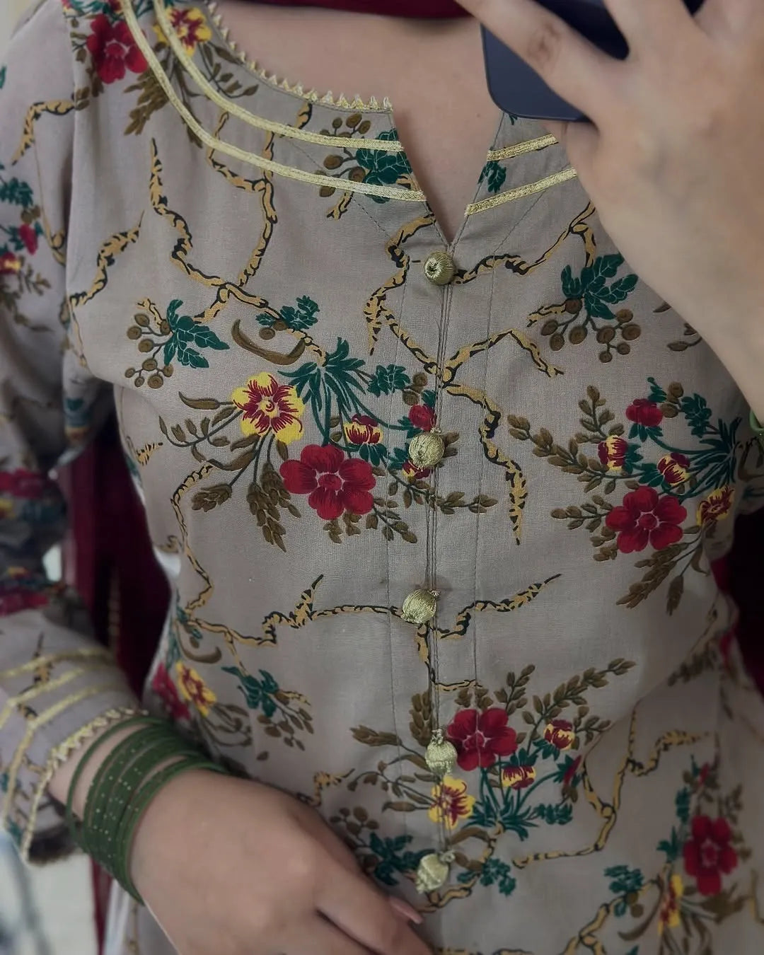Close-up of a floral embroidered shirt with colorful patterns.