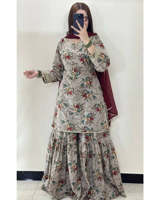 Person wearing a floral dress with a plain background