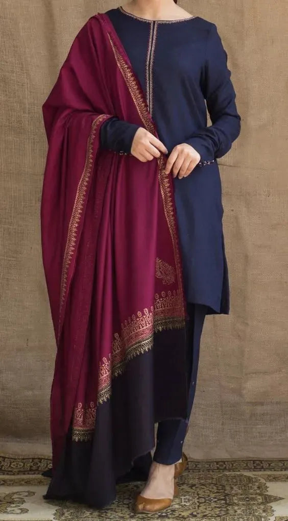 Navy blue kurta with a maroon dupatta draped over the shoulder against a beige wall.