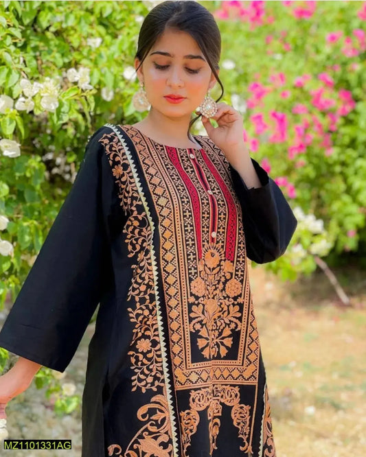 Woman wearing a black embroidered dress with a floral background