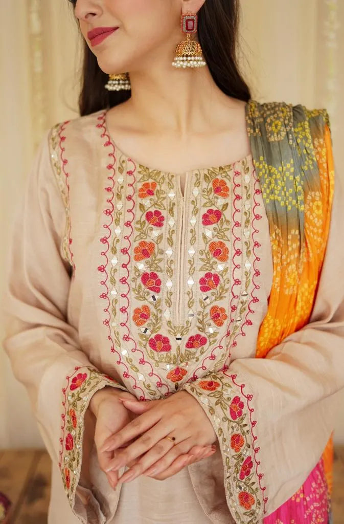 Woman wearing a traditional embroidered outfit with a blurred background