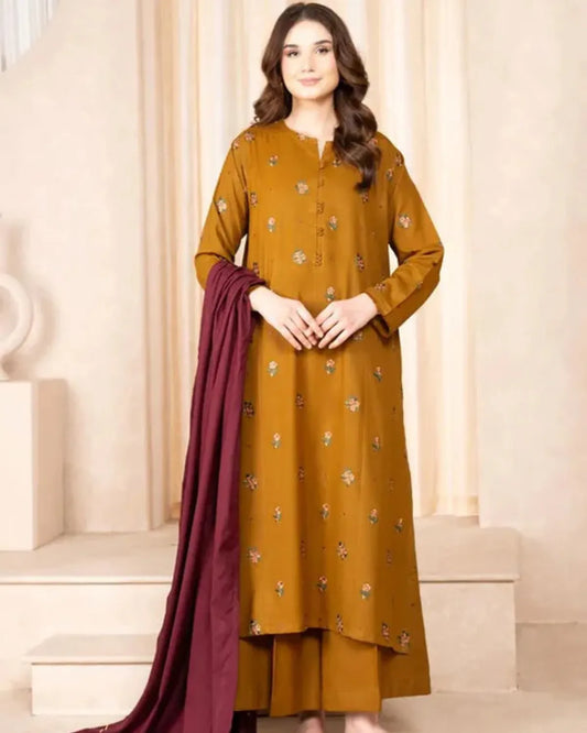 Woman wearing a mustard yellow traditional outfit with a maroon dupatta on a neutral background